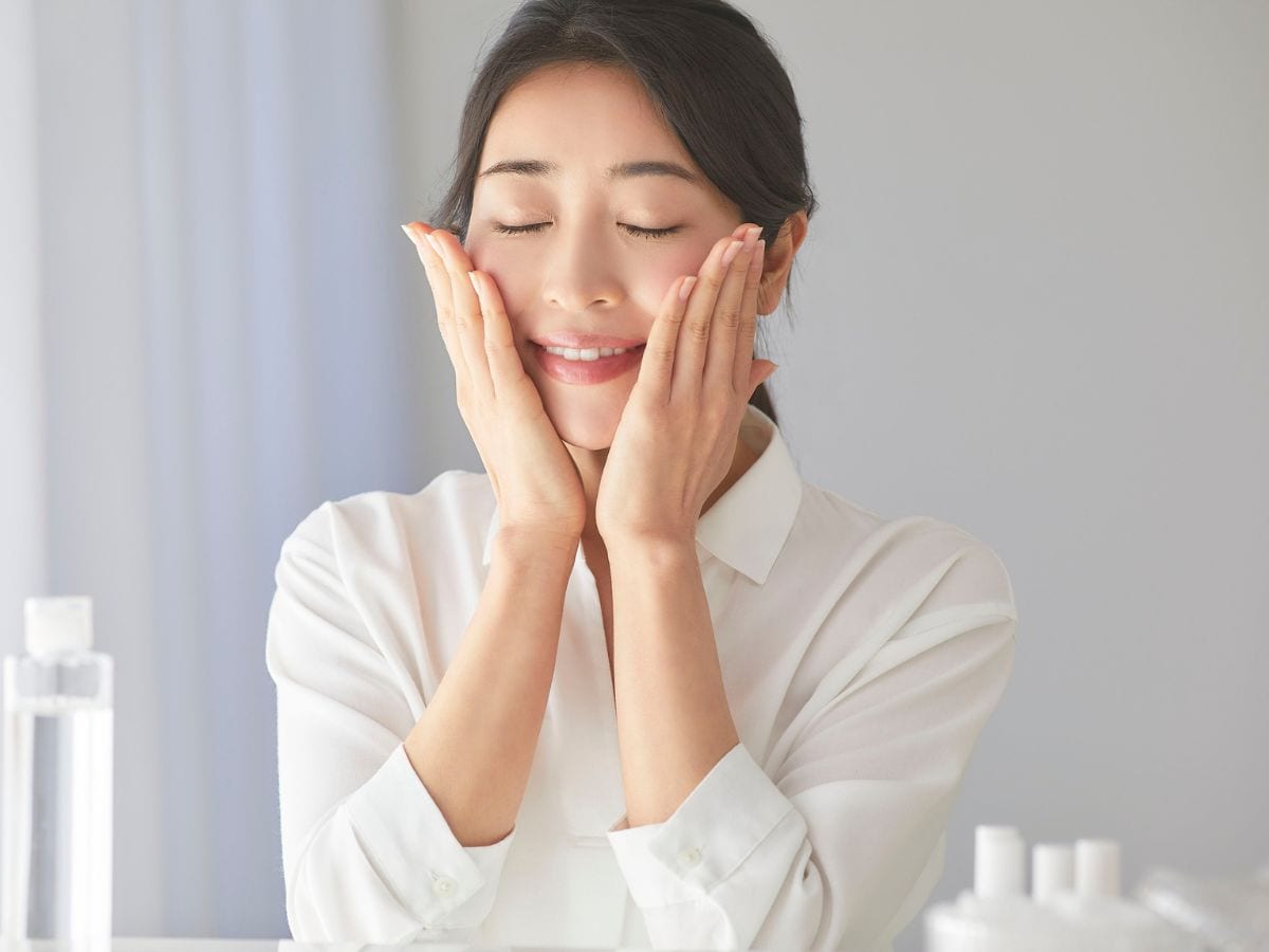 girl touch her face with two hands
