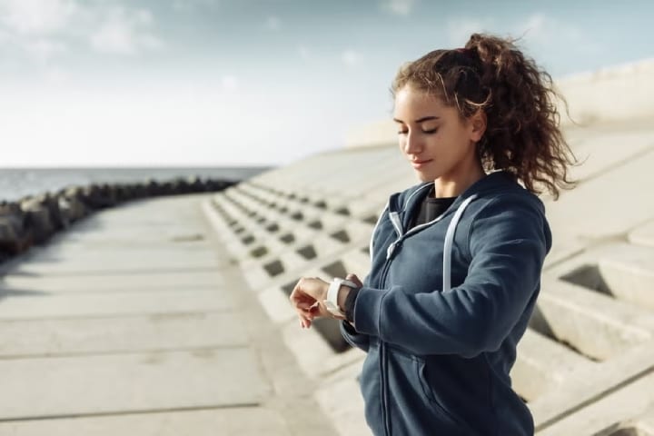 girl looking at her fitness watch