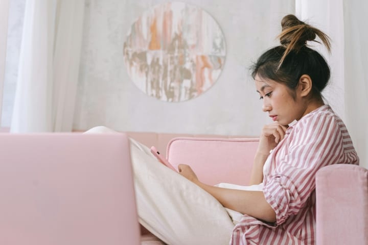 girl texting on sofa