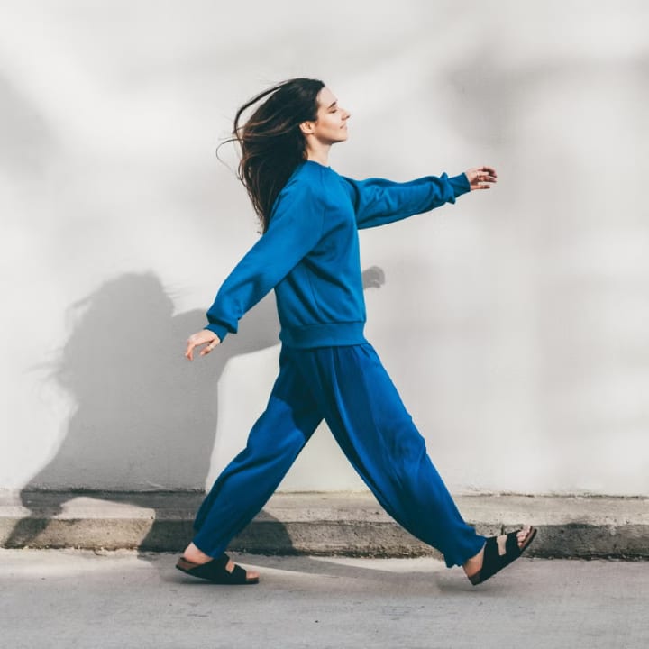 girl walking on the sidewalk