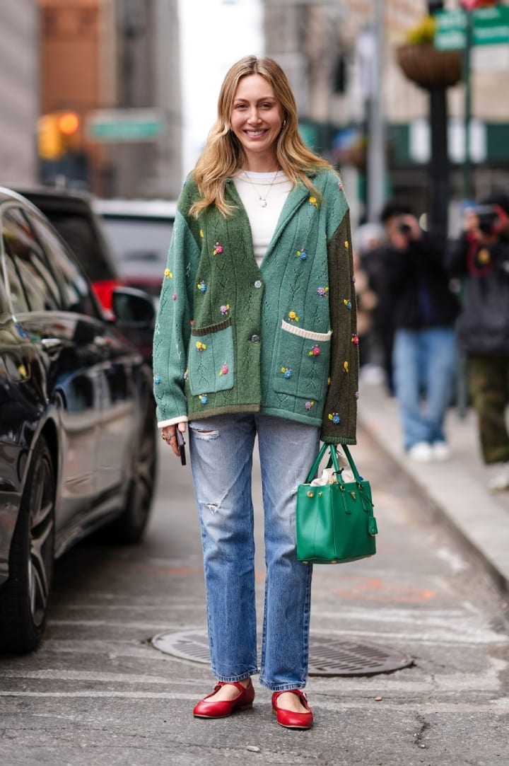 girl wearing green cardigan and distressed jeans
