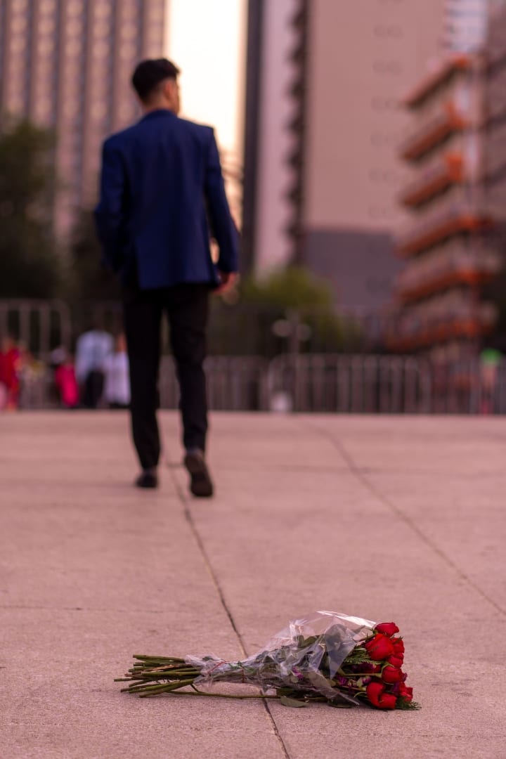 bouquet of roses left on the sidewalk