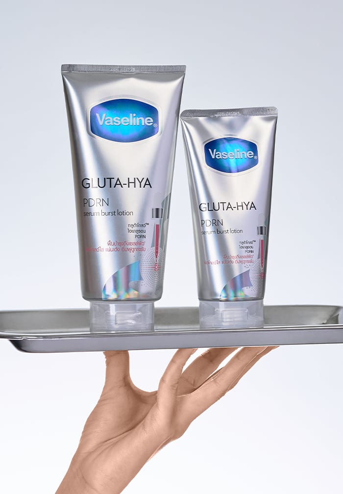 hand holding a tray with lotion on top